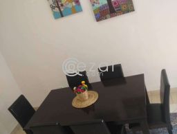 Dining table with 6 leather chairs for sale in Qatar