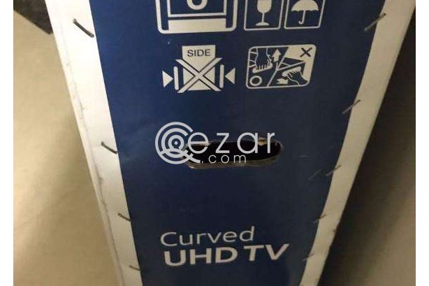 curved 55 inch UHD TV with quality glass cabinet photo 1